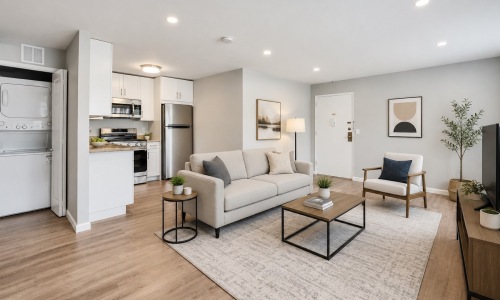 a living room with a couch, chair and tables