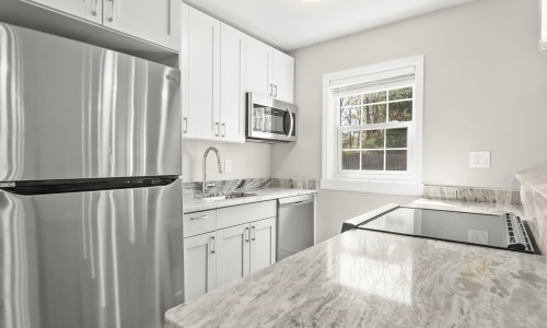 kitchen with ample counter-space modern appliances and bright lighting