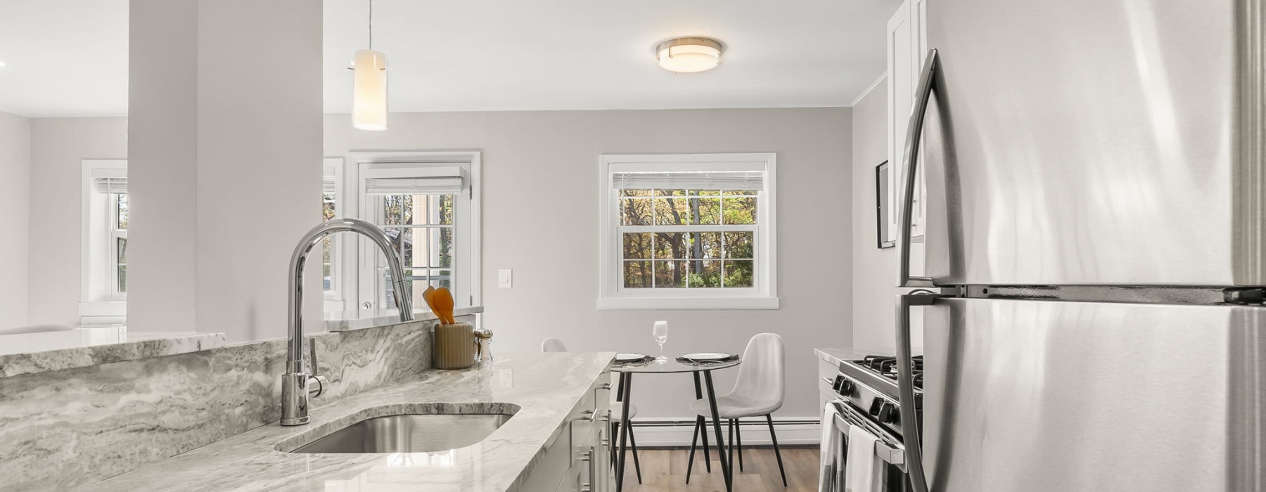 kitchen with stainless steel appliances and dining room in view