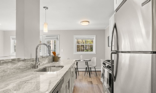 kitchen with stainless steel appliances and dining room in view